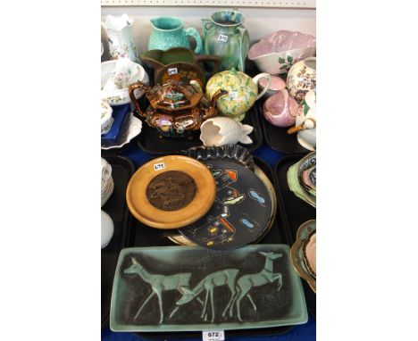 A Crown Ducal cowslip chintz teapot, a turquoise green pottery plaque with relief decoration of deer, impressed number 5115, 