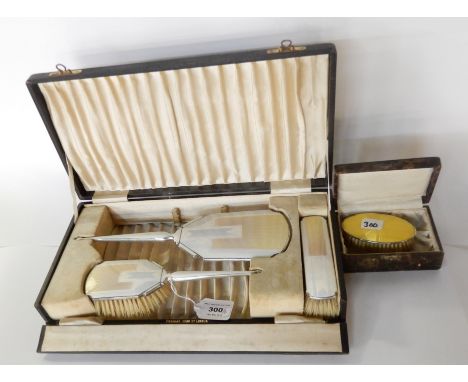 A lot comprising as cased three piece silver and enamel dressing table set, Birmingham 1936 and a cased silver and enamel bru