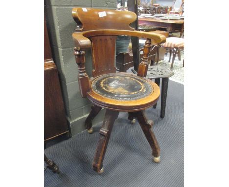 A mahogany swivel desk chair with circular leather inset seat and modern plastic castors  