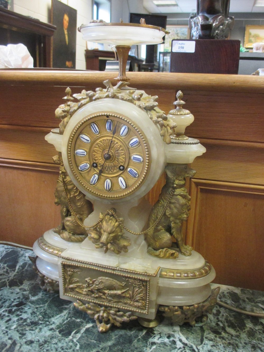 A Onyx mantel clock of hunting theme with dog and wild boar motiffs and ...