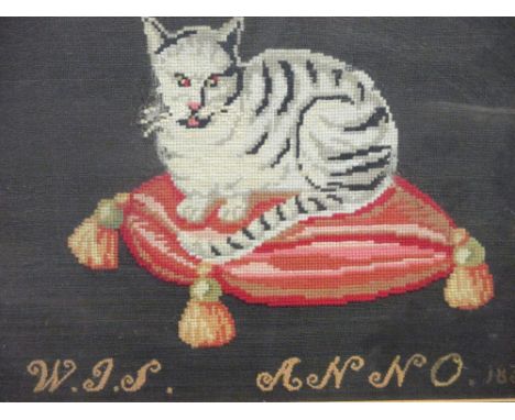A 19th century woolwork picture of a cat upon a cushion, 25 x 37cm  