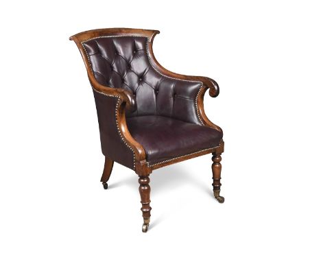 A Regency rosewood framed library armchair, with a waisted back and scroll carved arms, button upholstered in a dark chocolat