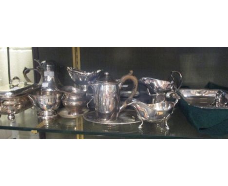 A collection of silver plated items including an entree dish, three sauce boats, two cream jugs, a hip flask, two hot water j