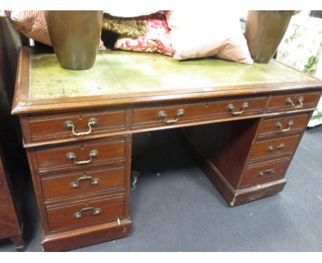 An Edwardian mahogany pedestal desk with green leather top, 74 x 135 x 67cm  