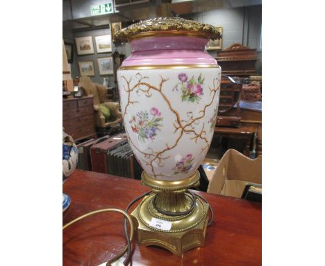 A continental porcelain and gilt metal oil lamp  