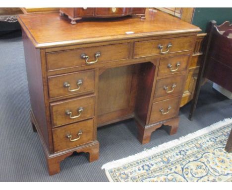 A George III and later mahogany kneehole desk, with brass swan neck handles on bracket feet, 73 x 88cm 