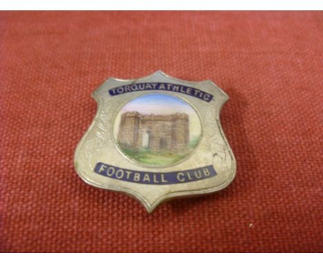 Torquay Utd, a metal and enamel badge, large shield style, with colour enamel picture of a Castle Gardens in set, possibly la