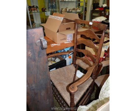 A late 19th c. Oak and rush Lancashire Armchair with ladder back bobbin turned detail.