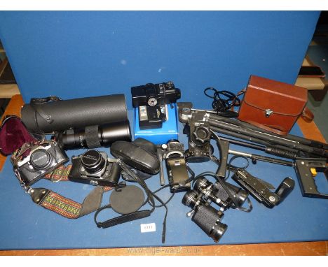 A quantity of cameras and accessories including tripod stands, flash gun, Pentax Asahi camera, Pentax ME Super and a Vivitar 