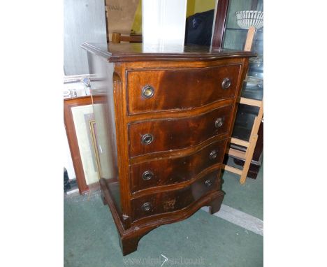 An older reproduction compact bow fronted, crossbanded Mahogany Chest of four short drawers having drop ring handles and stan