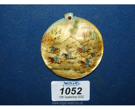 A large mother of pearl medallion painted with an oriental hunting scene, 2 1/4".