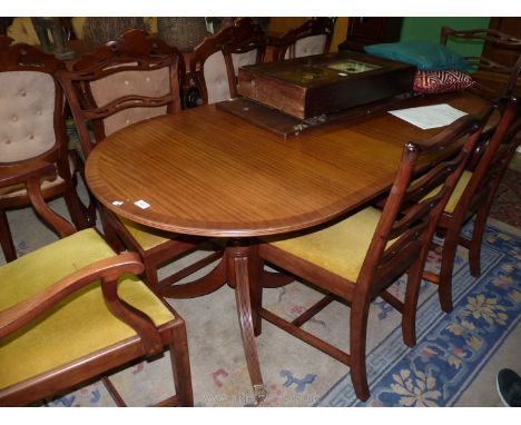 A JAS Schoolbred &amp; Co. Tottenham Court Rd, London crossbanded Mahogany Regency style Dining Table standing on two pedesta