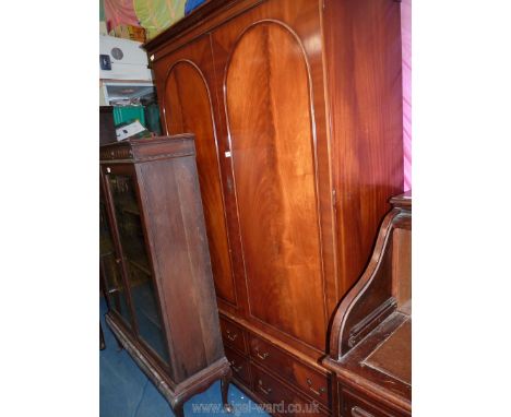 A flame mahogany double Wardrobe, the upper portion with a hat shelf and hanging rail, the base with four short drawers with 