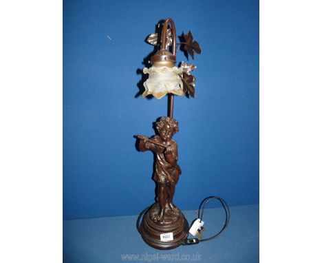 A bronzed effect Table lamp with boy playing flute, with glass shade, 26" tall.