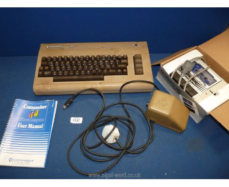 A Commadore 64 with user manual and a boxed Commodore 1530 Datassette unit model C2N.