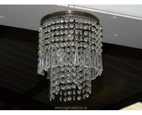 A two tier brass and drop crystal light fitting, 8" diameter.
