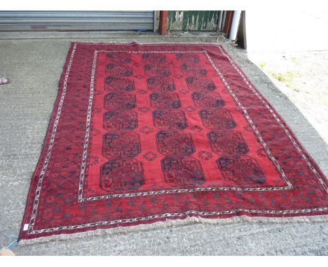 A large bordered, patterned and fringed red ground Carpet with octagonal shaped motifs,114'' x 85''.Oriental