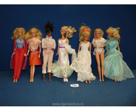 Seven Mattel ''Barbie'' dolls (made in the Philippines) including six with blonde hair and one brunette, and spring mechanism