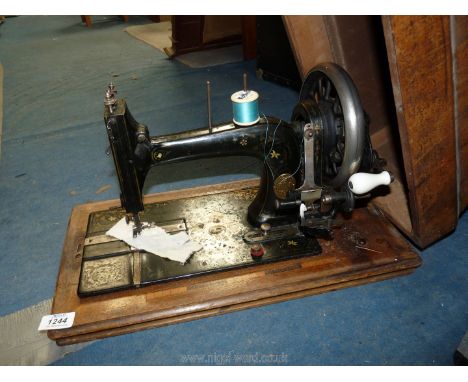 A German manual Sewing Machine decorated with flowers and mother of pearl, with key.