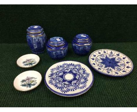 A pair of pottery blue and white glazed plates, two Royal Worcester pin dishes and three Ringtons 80th anniversary caddies 