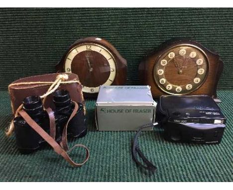 A basket of cased Cyma binoculars, cameras, together with a walnut Prescott mantle clock and one more clock