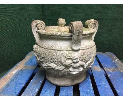 A stone garden cherub planter 