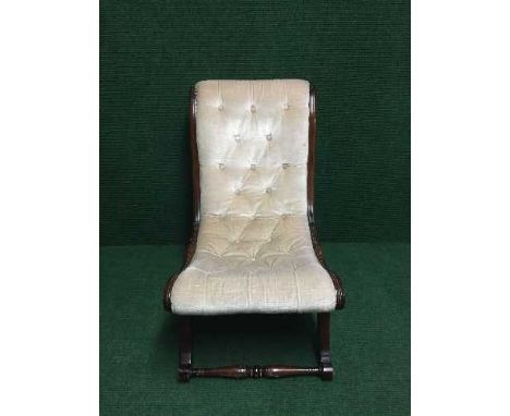 A mahogany nursing chair upholstered in beige button fabric 