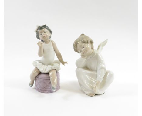 A Lladro figure of a little ballet dancer seated on a pouffe together with another of a seated angel