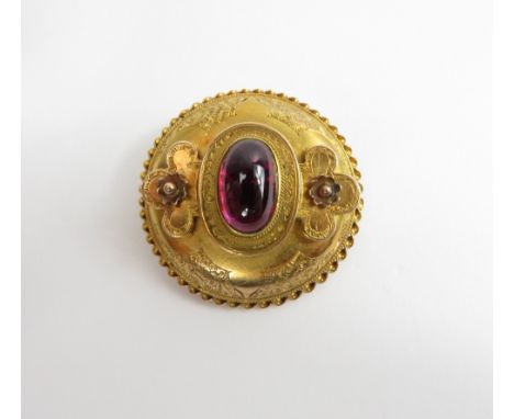 A Victorian cabochon garnet set gold brooch, unmarked, of circular outline, locket back, 3.5 cm diameter, 11 g gross