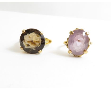 A smoky quartz single stone ring, stamped '585' and '14K', finger size P, 7 g gross; with a single stone pale amethyst ring, 