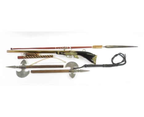 A vintage leather whip, along with axes, spears, replica gun and other items
