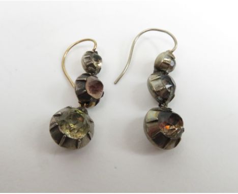 A pair of Victorian paste set drop earrings, the three graduated collet set stones to gold wires, approximately 2.4 cm long