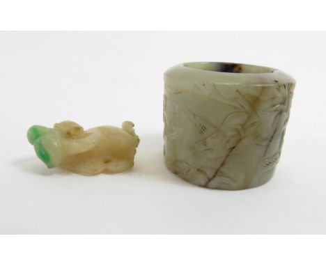 A Chinese Jade archers ring carved with various animals, along with smaller jade carving