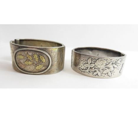 A Victorian silver hinged bangle, Birmingham 1870, with applied decoration to the frontispiece, 2.5 cm wide, internal diamete