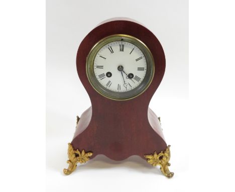 A mahogany mantel clock, raised on gilt metal mounts, with a white enamel dial and roman numerals, 31cm high
