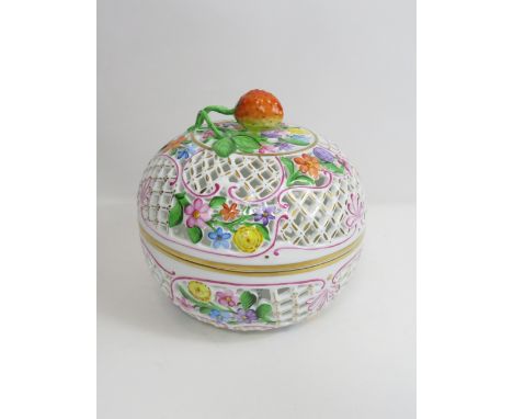 A Herend circular painted reticulated bowl and cover, with strawberry finial and colourful painted floral design 14.5cm high