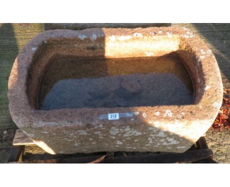A pink water trough of rectangular form and with rounded ends, 42cm high 89cm x 53.5cm