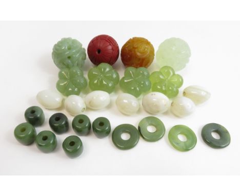 A collection of Chinese jade circular carvings, along with various other hardstone carvings