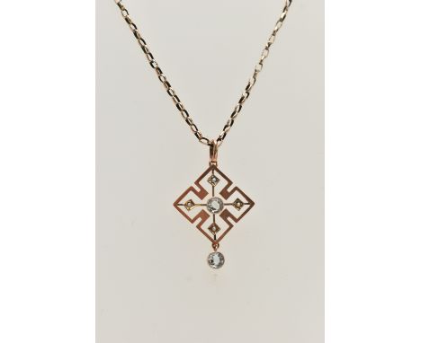 AN EARLY 20TH CENTURY ART DECO PENDANT, a rose gold quatrefoil open work pendant, principally set with a circular cut light b