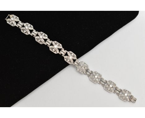 AN ART DECO STYLE DIAMOND BRACELET, nine white metal panels, each set with a single bezel set round brilliant, additionally g