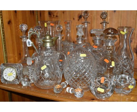 A GROUP OF CUT GLASS, comprising a Victorian cut crystal claret jug with a silverplate lid and handle, nine decanters, two la