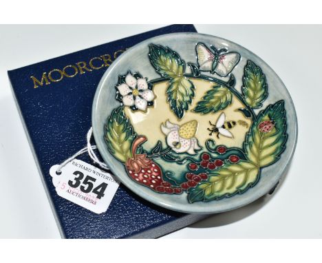 A BOXED MOORCROFT POTTERY 'FRUIT GARDEN' PATTERN TRINKET DISH, impressed and painted marks, gold pen signature N. Slaney on t
