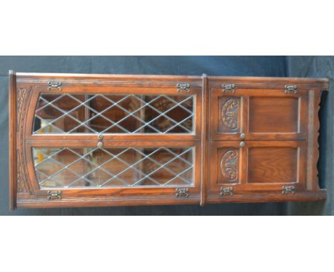 An oak Old charm floor standing corner cabinet with glazed leaded light.
