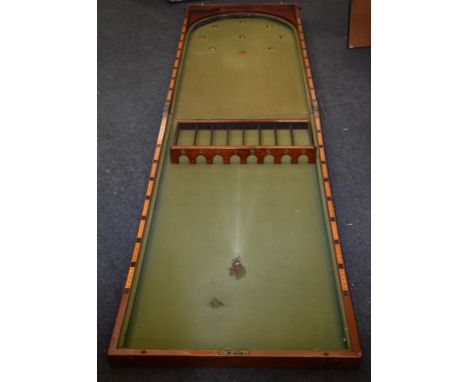 A large Victorian mahogany bagatelle, hinged cover enclosing a playing surface, 137cm x 71cm (folded), c.1860; cues and acces