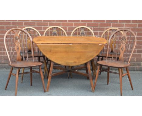 An Ercol drop leaf table and six Ercol chairs