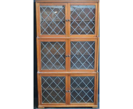 A mahogany three tier stepped bookcase with glazed leaded light