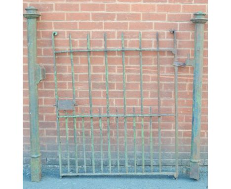 A wrought iron gate and post