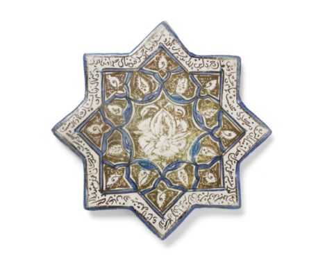 A Kashan lustre pottery star tile Persia, 13th/14th Centurywith eight points, decorated in cobalt blue and a brownish gold lu