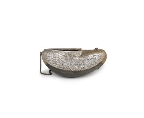 A Qajar silver and brass-mounted coco de mer kashkul Persia, 19th/ 20th Centuryof typical form, mounted with silver and brass