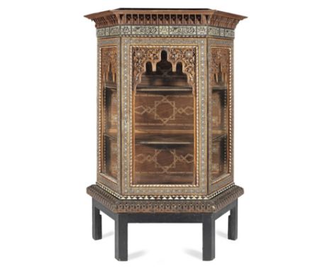 A Nasrid revival marquetry wood vitrine Granada, Circa 1900of multi-faceted form with hinged glass door to front, glass panel